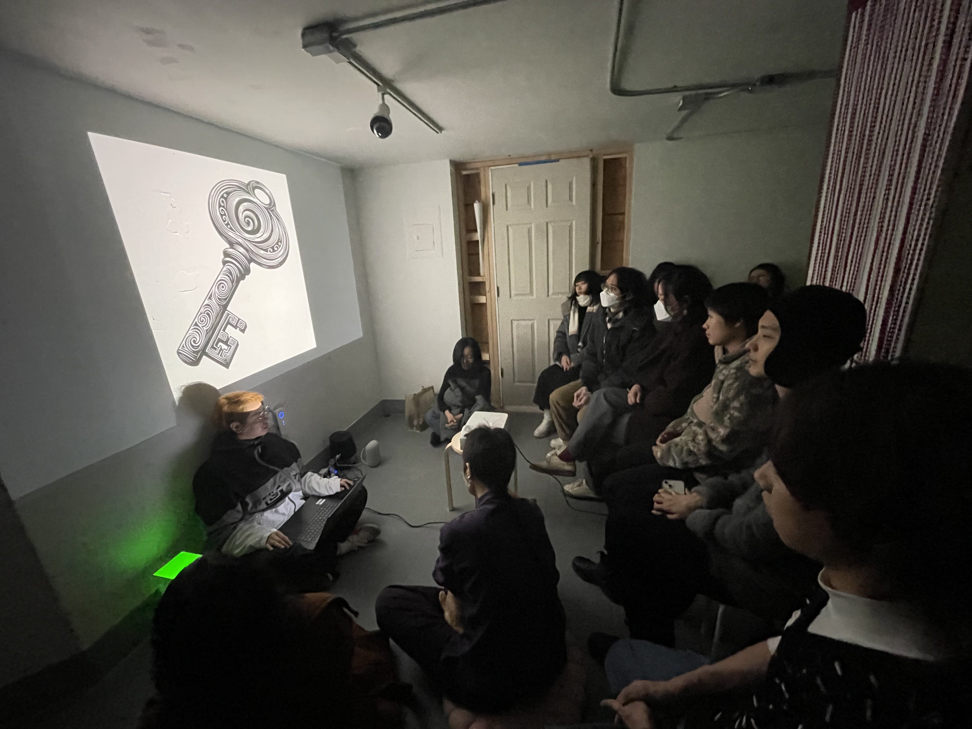 Zhenzhen Qi Leading the Collaborative Worldbuilding, with the Real-Time Generated Symbols Projected onto the Wall